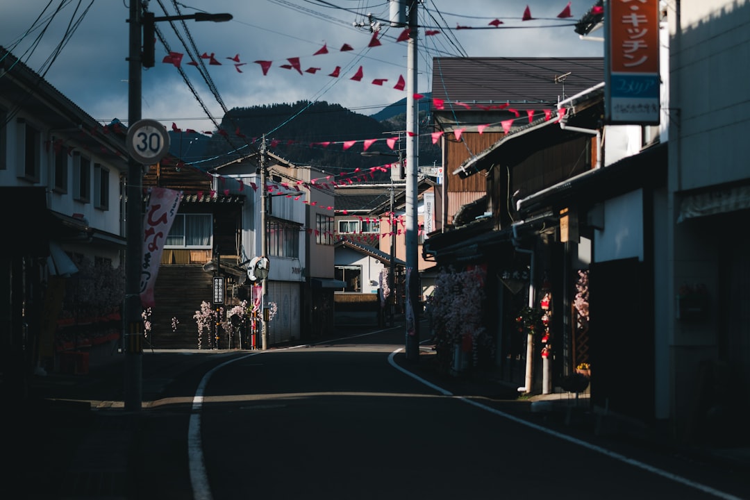 a narrow street with buildings and a sign on the side of it