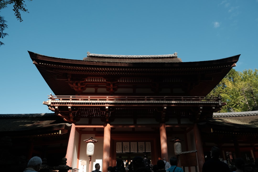 Traditional japanese temple gate under a clear blue sky.
