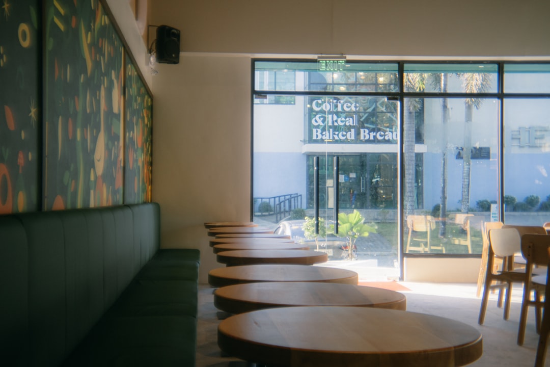 Empty cafe with tables and green booth seating