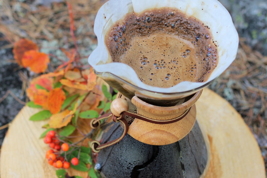 a coffee pot on top of a wooden stand