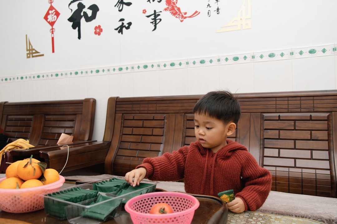 A young boy plays with toys on a table.