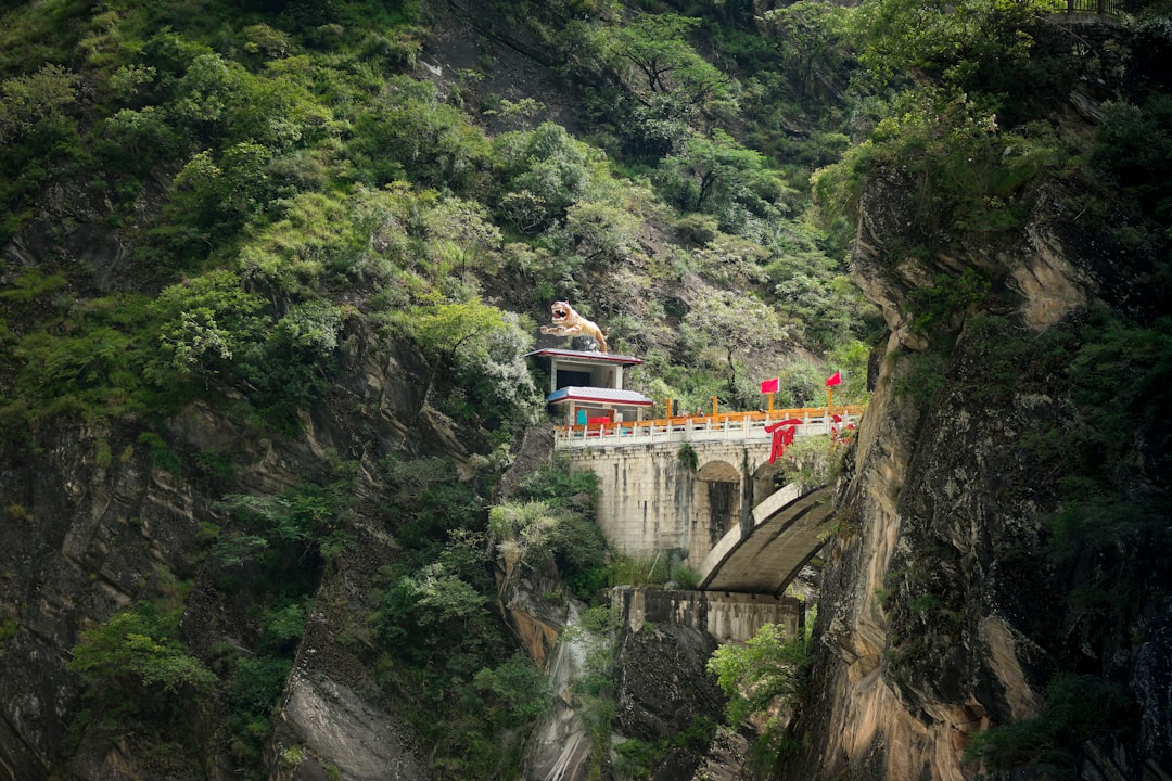 Temple nestled on a steep, green mountainside.