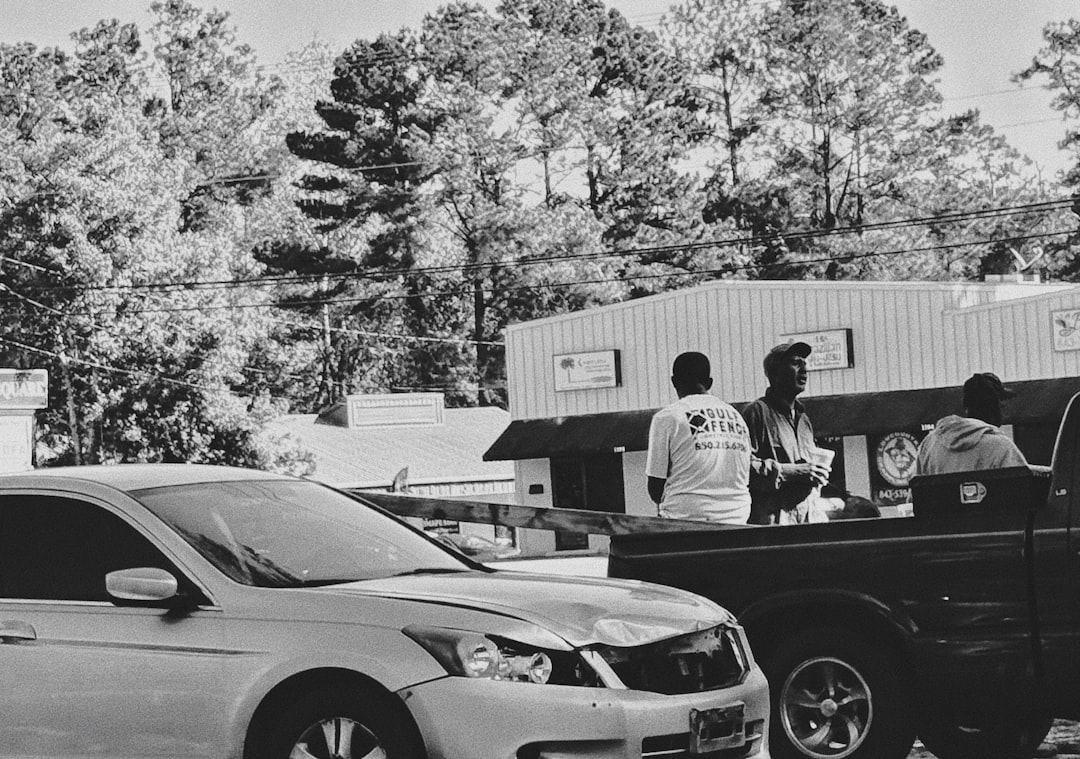 People gathered by vehicles outside a building